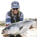 Fisherman holding Striped Bass